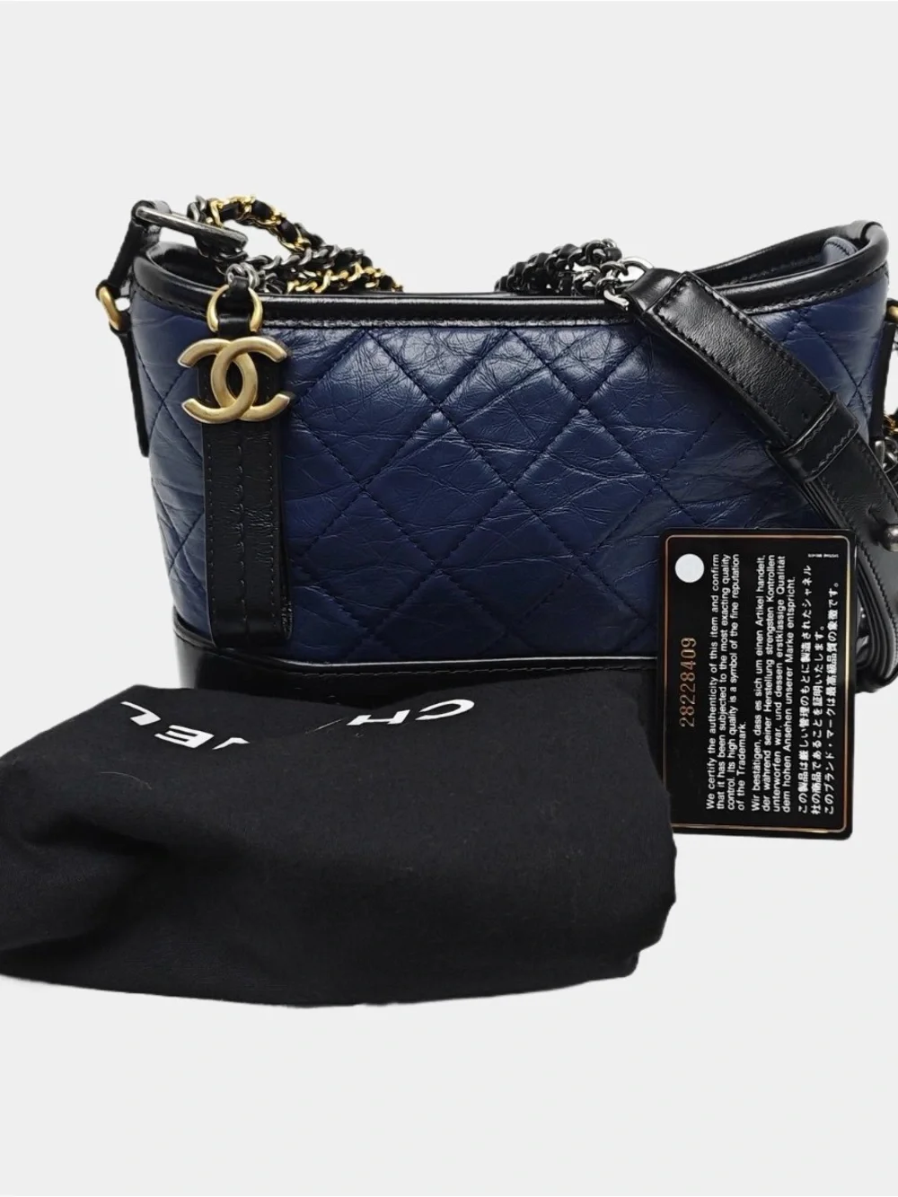 CHANEL Quilted Navy Leather Shoulder Bag with Black Trim and Gold CC Charm